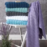 Elegance Turkish cotton towels in several colors on a white chair