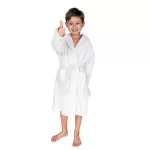 Smiling boy giving a thumbs up in a white hooded kids bathrobe