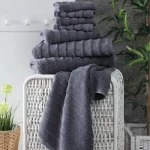 Charcoal Elegance towels in a woven basket
