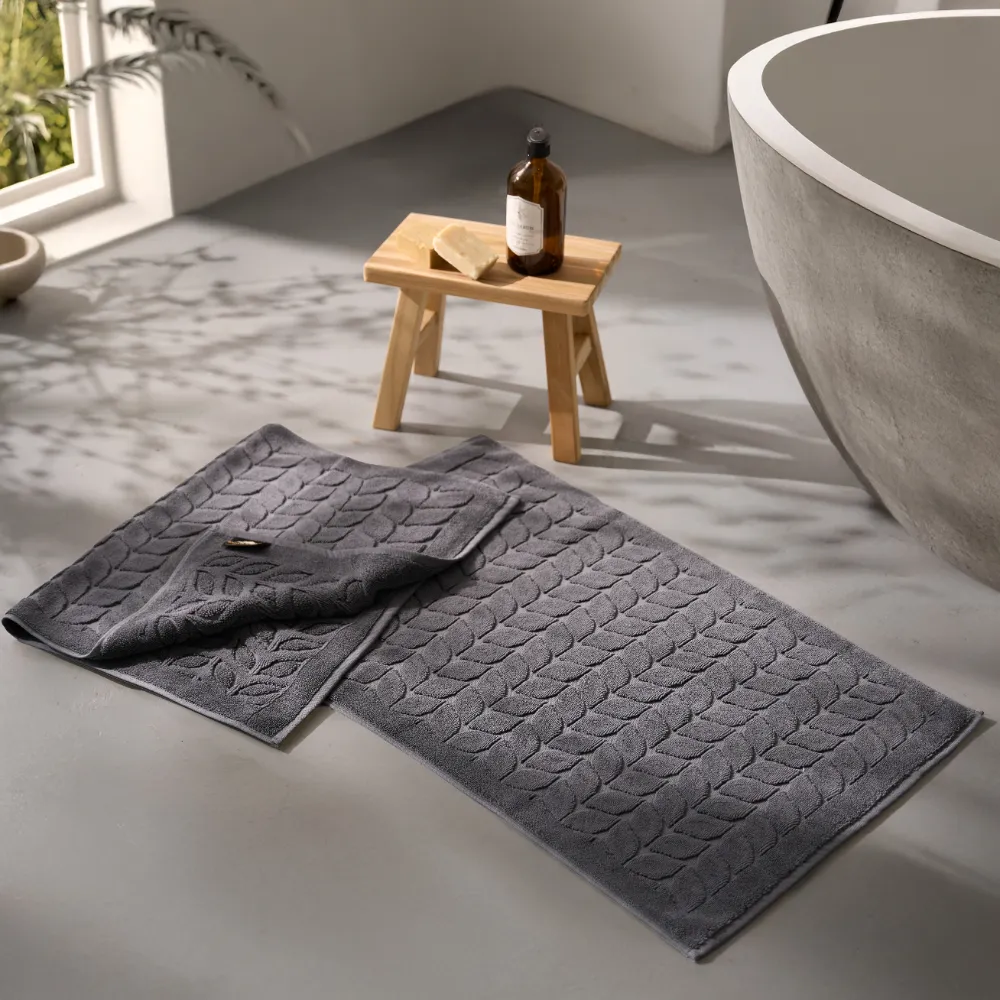 Grey Bagno Milano jacquard bath mat on a bathroom floor
