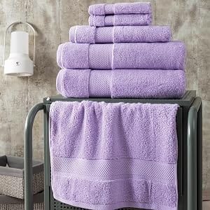 Lilac Bagno Milano Hotel Collection towels folded and hanging on a bathroom rack