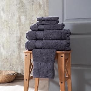 Charcoal Bagno Milano Hotel Collection 6-piece towel set on a wooden stool