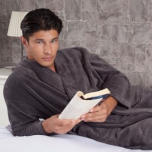 Man in charcoal gray Organic Cotton Soft Terry Robe (Hotel Collection) reading a book on a bed - Bagno Milano