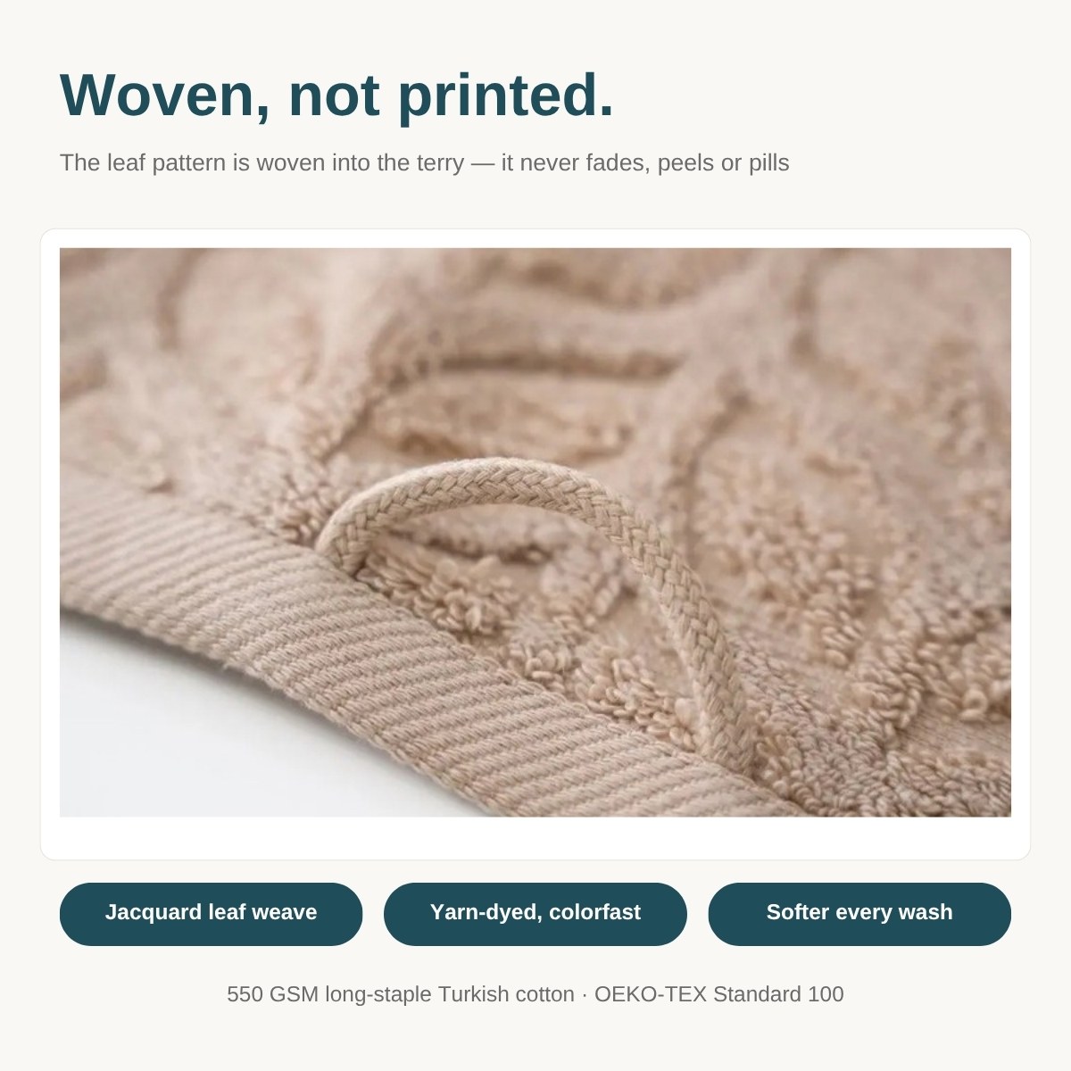 Close-up of the woven jacquard leaf pattern on a sand beige Bagno Milano Auraline towel