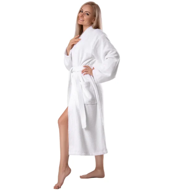Side view of a woman in a white terry cotton robe with a patch pocket and self-tie belt